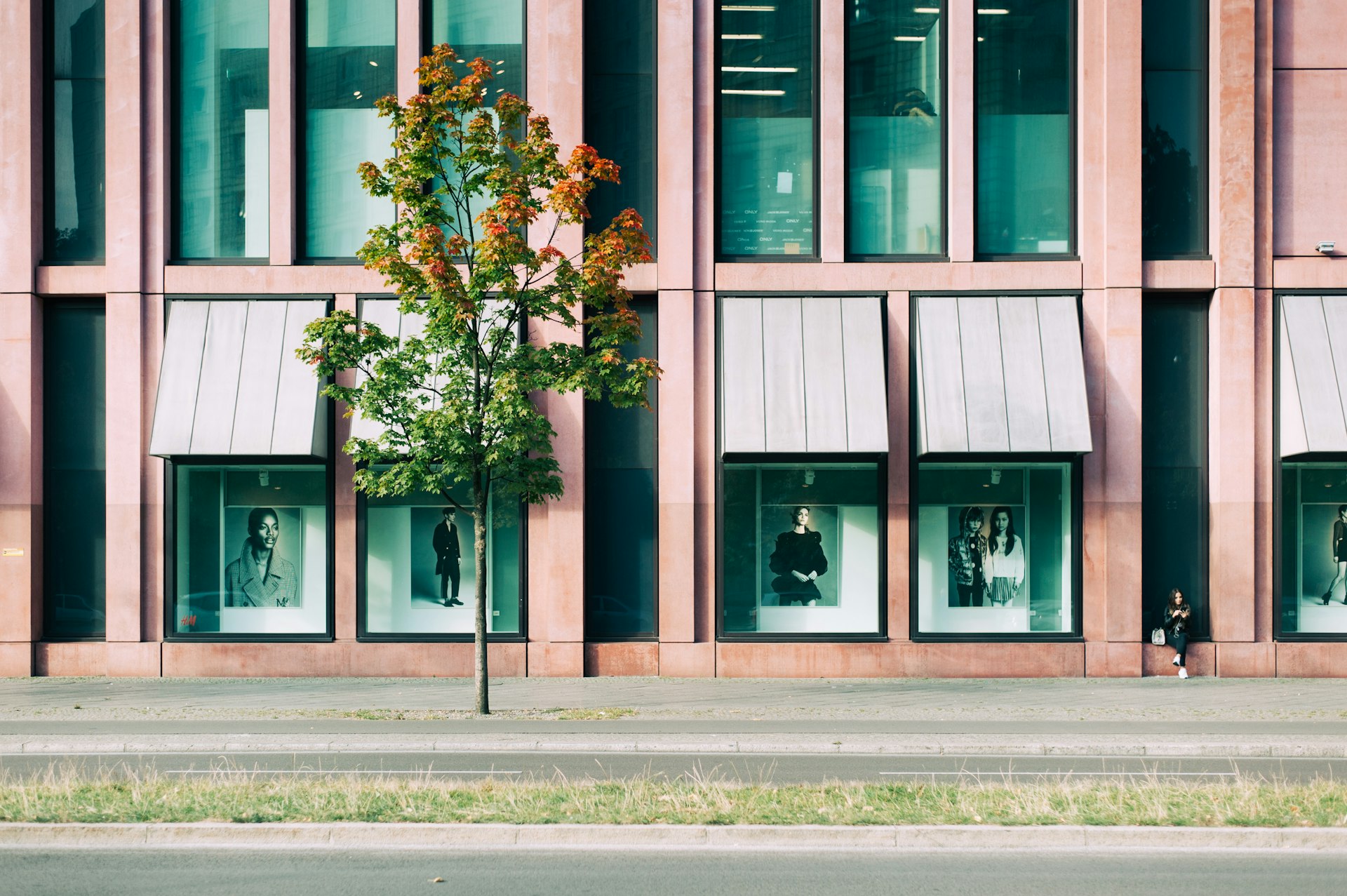 Storefront with fashion portraits in windows. Showcasing stylish fashion displays